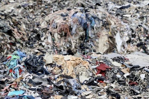 Discarded unwanted clothing ends up in landfill polluting the environment sustainable fashion