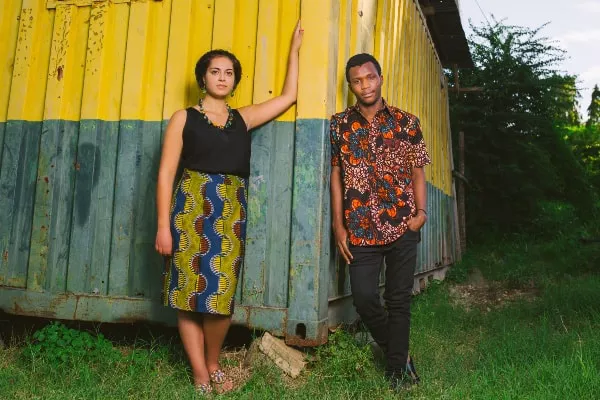 Models wearing men's African print shirt and women's African print pencil skirt by Kitenge