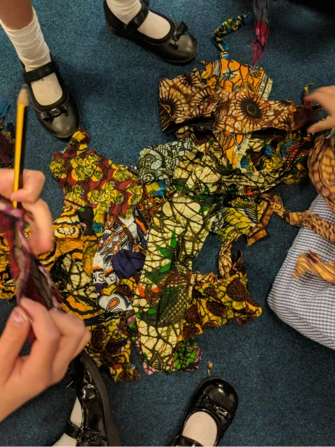 Primary school children inspired by African wax print fabrics art printing class