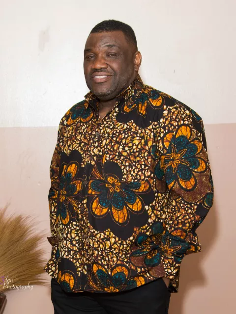 Kitenge customer modelling his African print shirts for men in the US