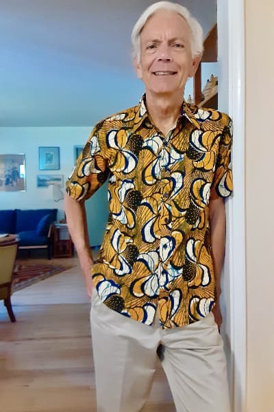 Kitenge customer wearing men's yellow African print fabric made to measure shirt with short sleeves in USA