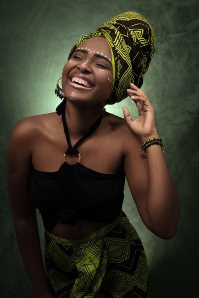 Model wearing African headwrap with matching African print skirt