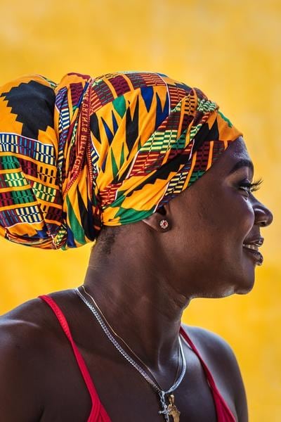 Model wearing Kente African print fabric headwrap